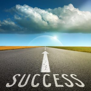 Empty asphalt road towards the big cloud and signs symbolizing success and safety